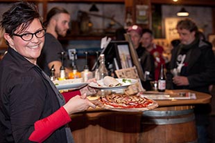 Waitress holding pizza
